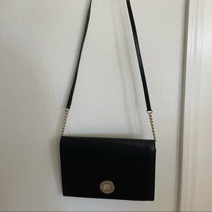 Kate Spade chic black evening bag with classic gold details.